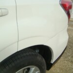 Before and after photographs of a damaged white Subaru that was repaired by Elite Paint & Body Shop in West Palm Beach, Florida